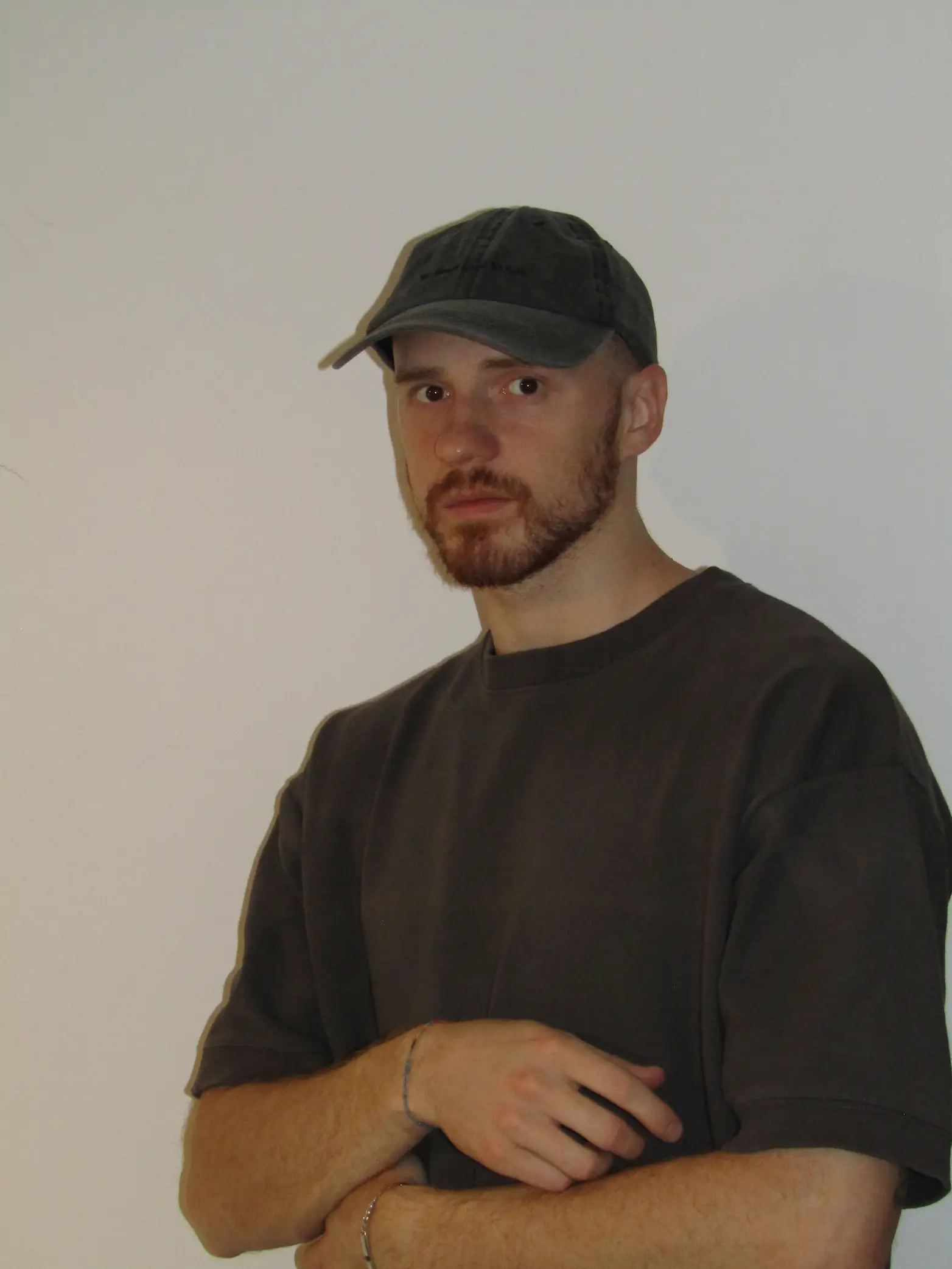 Lorenzo Lannino wearing a grey shirt and a hat